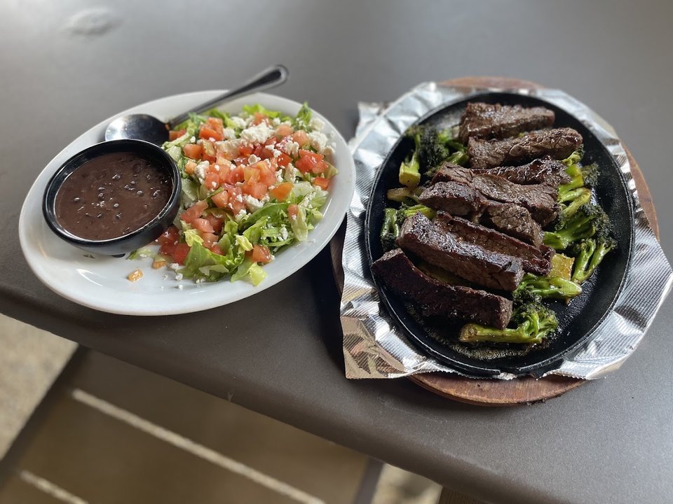 Freshly served meals beside bright tableware.